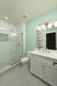 Bathroom with custom tile and built-in shelving