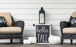 Stylish fall decorations in black and white on the front porch - hello fall