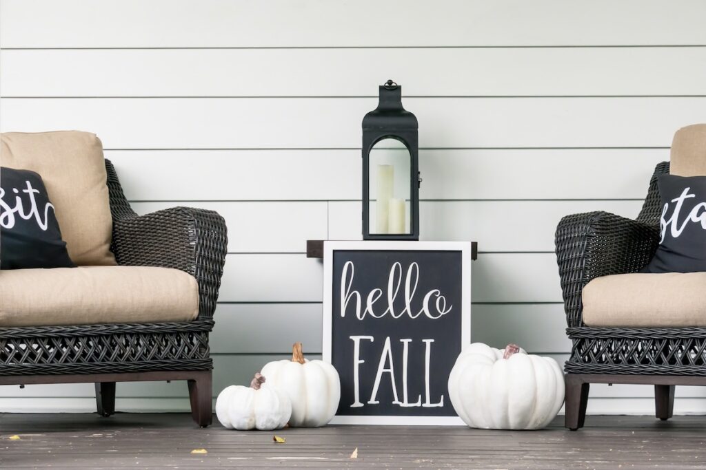 Stylish fall decorations in black and white on the front porch - hello fall